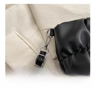 Close-up of black pleated cloud bag with silver metal hooks and premium PU texture