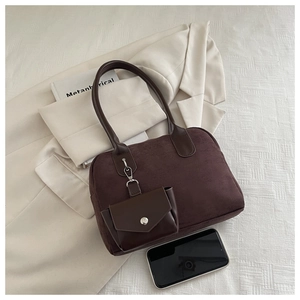 Close-up of matte dark brown suede tote bag with matching small coin pouch attachment