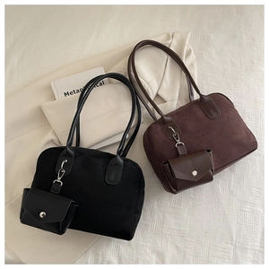 Detail of minimalist suede tote bags in black and coffee brown with matching pouches