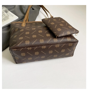 Close-up of printed tote bag and pouch set showing pebbled faux leather texture