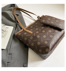 Detailed view of printed tote bag set with matching pouch on a grey blazer background