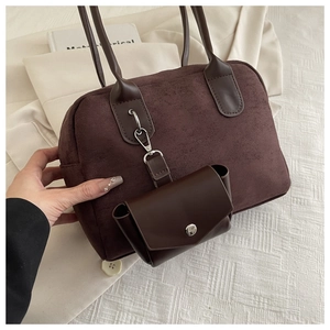 Detail of dark brown suede tote bag with contrast leather coin purse and strap