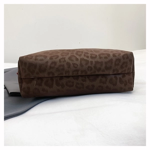 Close-up of the reinforced bottom and leopard print texture on this large tote bag