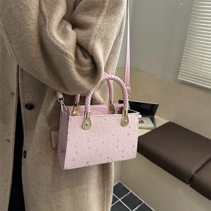 Pink mini crossbody bag with silver star prints and braided rope handle for women