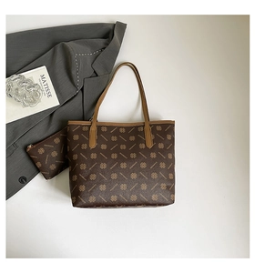 Close-up of vintage brown tote bag set with geometric print and matching small pouch