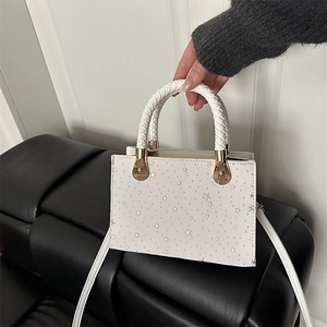 Minimalist white crossbody bag with silver star sequins and woven top handle