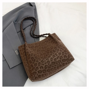Detail of leopard print tote bag with woven straps and soft faux suede texture