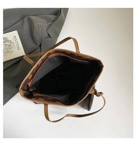 Detailed interior of brown tote bag showing printed lining and small zip pouch insert