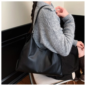 Detail of a black leather Hobo bag with visible soft texture and spacious interior