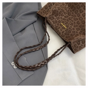 Close-up of leopard print shoulder bag with Creative Cat gold text on woolly fabric
