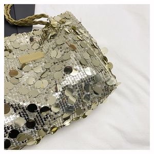 Detail showing shiny gold sequins and stitched Fashion Bags label on shoulder bag