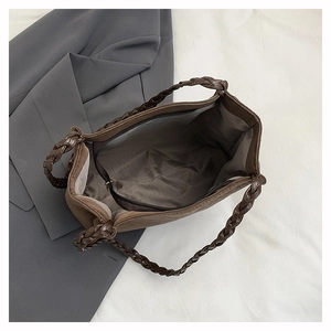 Close-up of the woven handle and spacious interior with a zipper pocket of this tote bag