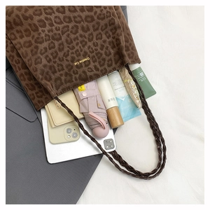 Top view of spacious leopard print tote bag showing organized interior essentials