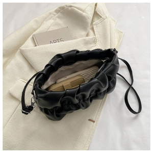 Close-up of the black ruched cloud bag interior showing space for wallet and phone