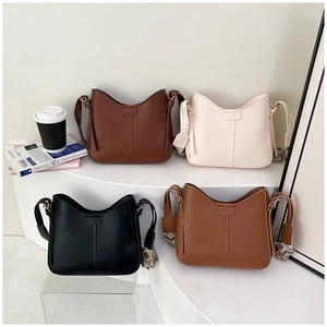 Four minimalist crossbody bags in retro colors with geometric wide fabric straps on display