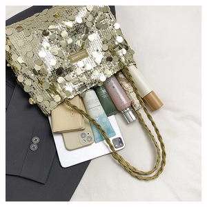 Detail showing high-capacity interior of gold sequin tote bag with daily essentials