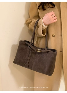 Detail of vintage matte tote bag with slim shoulder strap and golden metal buckle