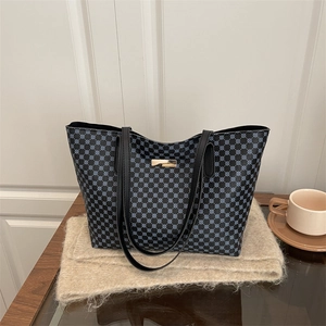 Chic tote bag with blue grid pattern and gold accent on soft white background