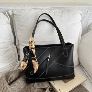 Retro black leather tote bag with contrast stitching, top handles and printed silk scarf
