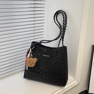 Minimalist black leopard print tote bag with woven handles and cute bear charm
