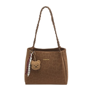 Brown faux leather tote bag with Creative Cat print and plush bear charm on white background