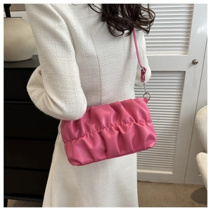 Detailed view of Rose Pink pleated shoulder bag featuring soft PU leather and silver hardware