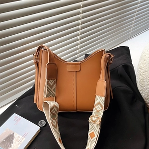 Brown faux leather shoulder bag with stylish green geometric pattern woven strap