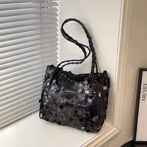 Fashionable black sequin tote bag with woven handles and large reflective sequins