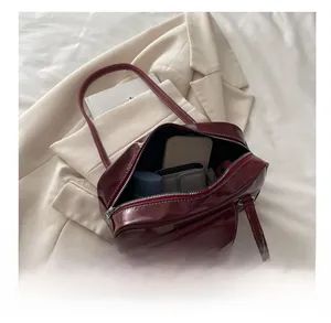 Interior view of large burgundy bowling bag showing space for phone and wallet