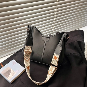 Minimalist black leather crossbody bag with ethnic jacquard wide shoulder strap for women