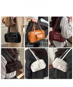 Detail showing five colors of leather Boston shoulder bags with contrast stitching