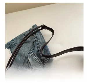 Detail of dark brown leather handle on vintage shoulder bag with neat edge finishing
