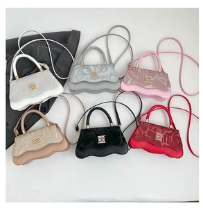 Detail view of the wave-patterned shoulder bags in six vibrant colors with golden hardware