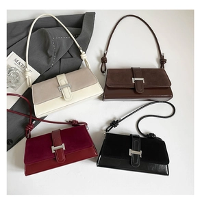 Detail showing the mixed suede texture and silver metal hardware of the small square bags