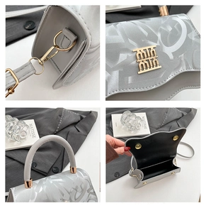 Detailed views of gray patterned handbag with gold metal clasp and interior space