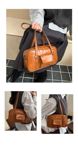 Close-up of vintage brown oil wax leather bowling bag with white stitching details