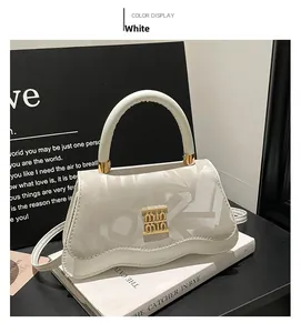Detail of white leather shoulder bag with embossed letters and wavy base design