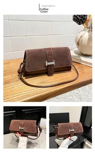 Close-up of coffee brown suede shoulder bag with metallic H-shaped buckle detail