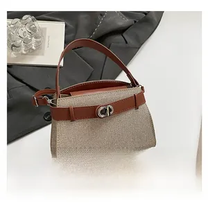 Close-up of retro woven handbag with brown leather trim and silver metal twist lock detail