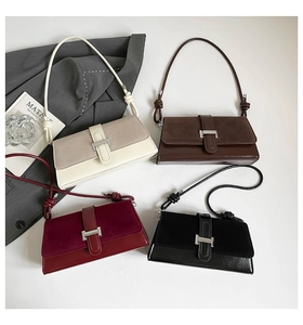 Close-up of vintage baguette bags in four colors with metallic buckles and knot details
