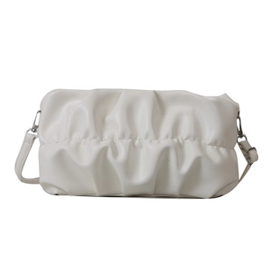 Minimalist white pleated baguette shoulder bag with slim strap in a clean studio view