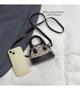 Mini vintage pattern crossbody bag shown next to an iPhone for size comparison