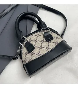 Close-up of black leather stitching and vintage monogram canvas on the shell bag