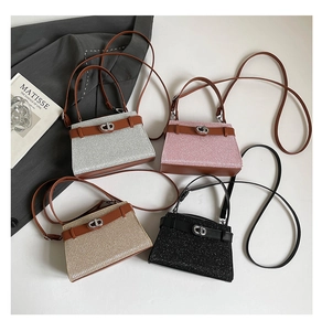 Detail of four glitter trapezoid handbags in silver, pink, gold and black with CD metal buckles