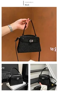 Detail of black glitter crossbody bag with metallic CD buckle and adjustable leather strap