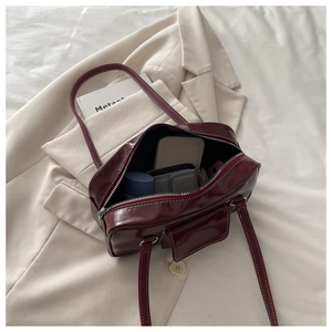 Top-down view of retro dark red handbag interior showing spacious storage for phone and wallet