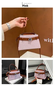 Detail of pink sequin handbag with brown leather trim and silver metal CD buckle closure