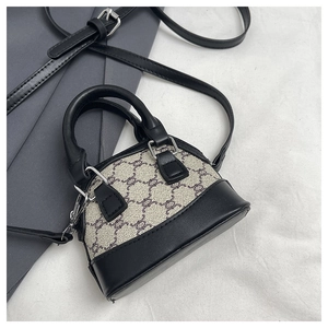 Detail of mini shell-shaped crossbody bag featuring vintage print and black leather trim
