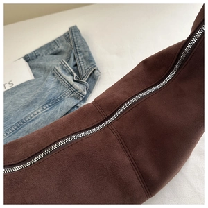 Detail of dark brown suede tote bag with durable silver zipper and smooth stitching