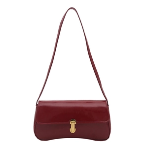 Dark red patent leather baguette bag with a gold rectangular buckle on white background